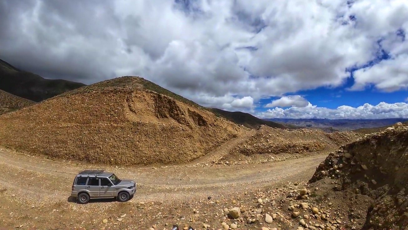 4WD jeep driving along a rugged mountain road in Upper Mustang.