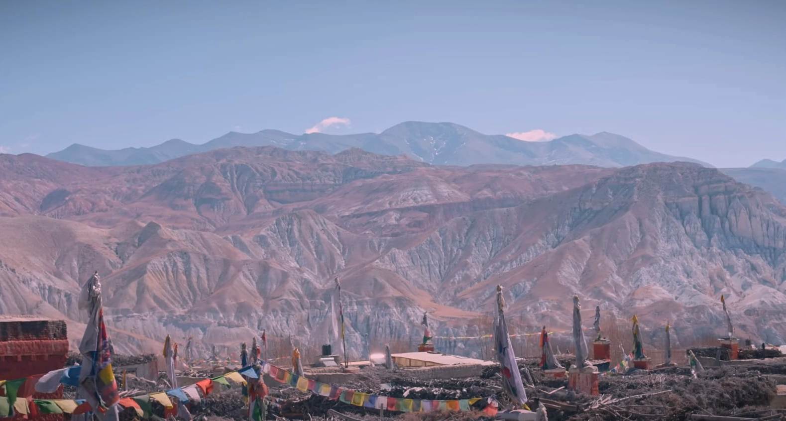 Upper Mustang Motorbike Tour riding through the desert landscape of Nepal’s Forbidden Kingdom with Himalayan mountains